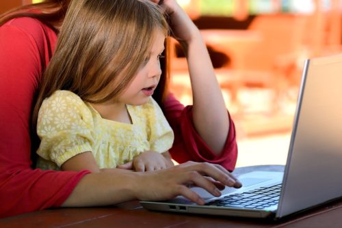 child viewing laptop
