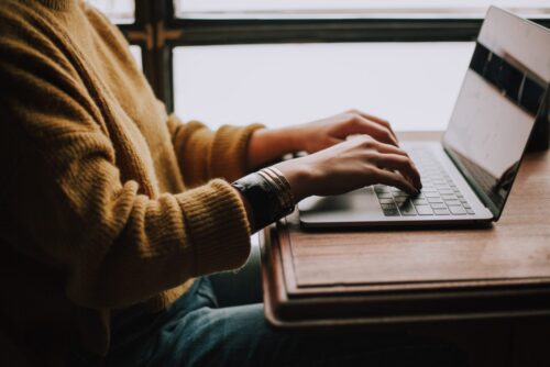 women typing laptop