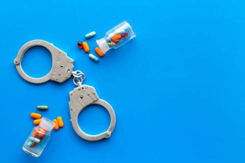 handcuffs drug bottles